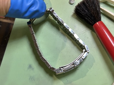 保持台に固定されたベルトのピンを打ち抜く工具。