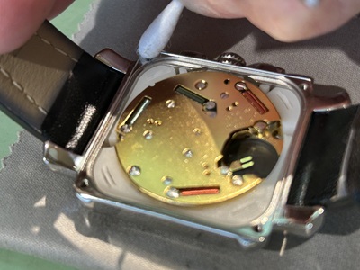 ケース内側の密閉面を綿棒で清掃している工程