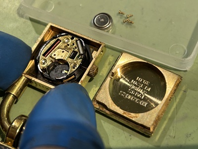 精密ドライバーを使用してエルメス・ケリーのサイドネジを緩めている手元。