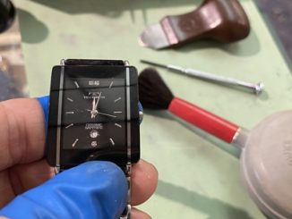 時刻合わせが完了し、作業デスクの上にあるテクノスの黒い文字盤の腕時計